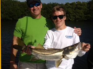 father and son snook on fishing charter